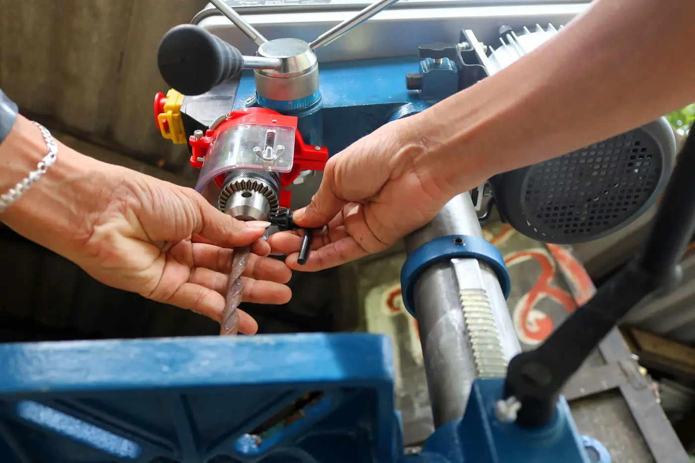 Drill presses machine with machinist. Worker use the Drill presses machine in the workshop.
