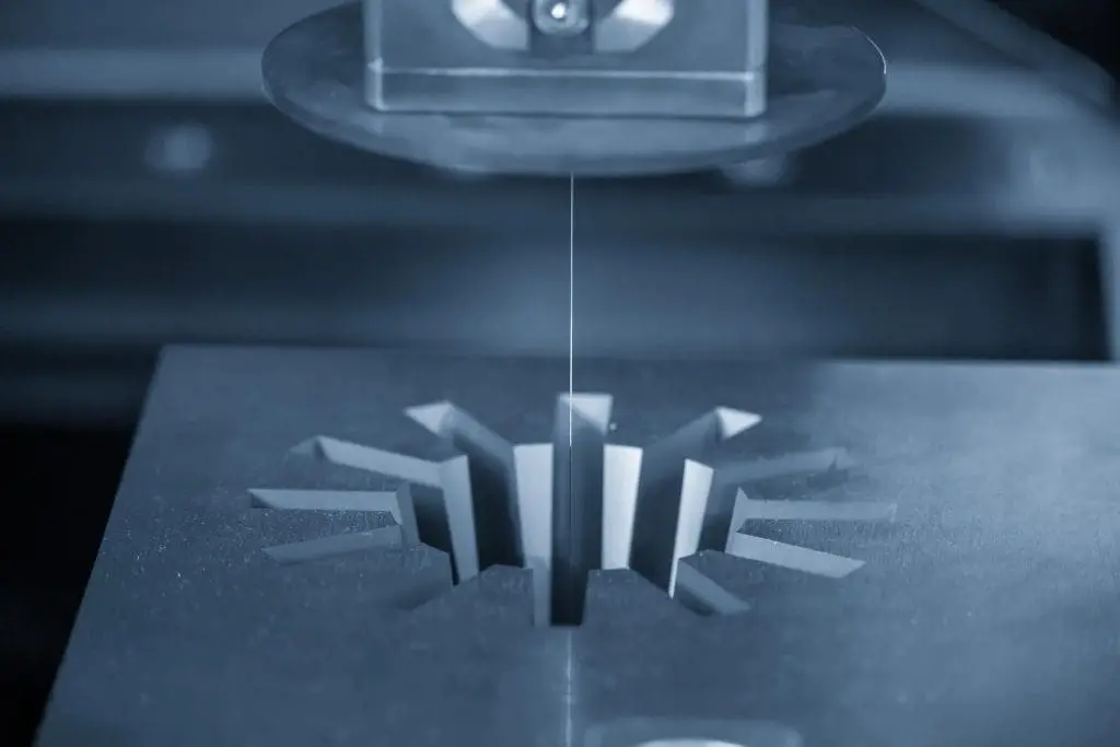 The Wire EDM machine cutting the gear shape of die insert. The mold and die manufacturing process by wire cut machine control by CNC program